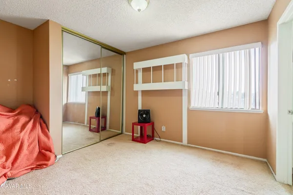 a living room with furniture and gym equipment