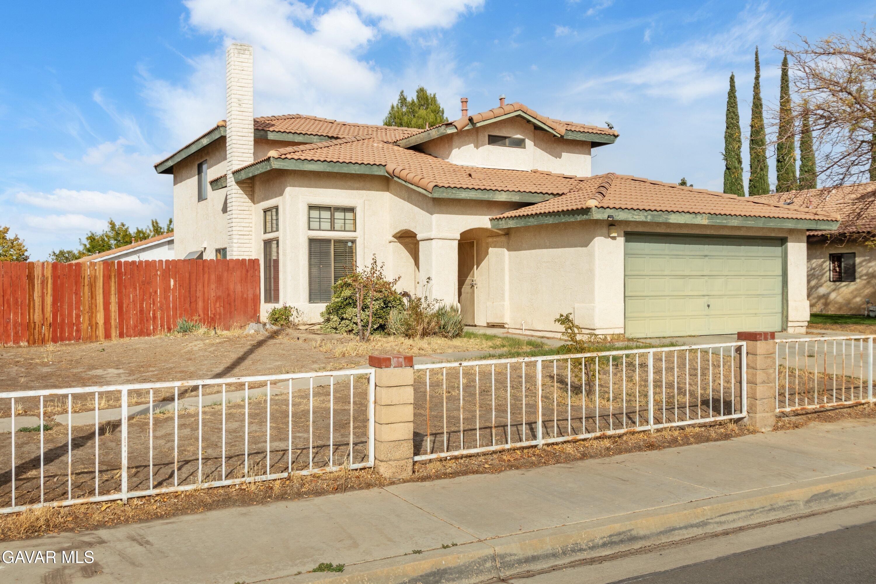 4625 Avenue R6 E Palmdale Ca East Palmdale, CA 93552 - Photo 2 of 25 a view of a house with a wooden fence