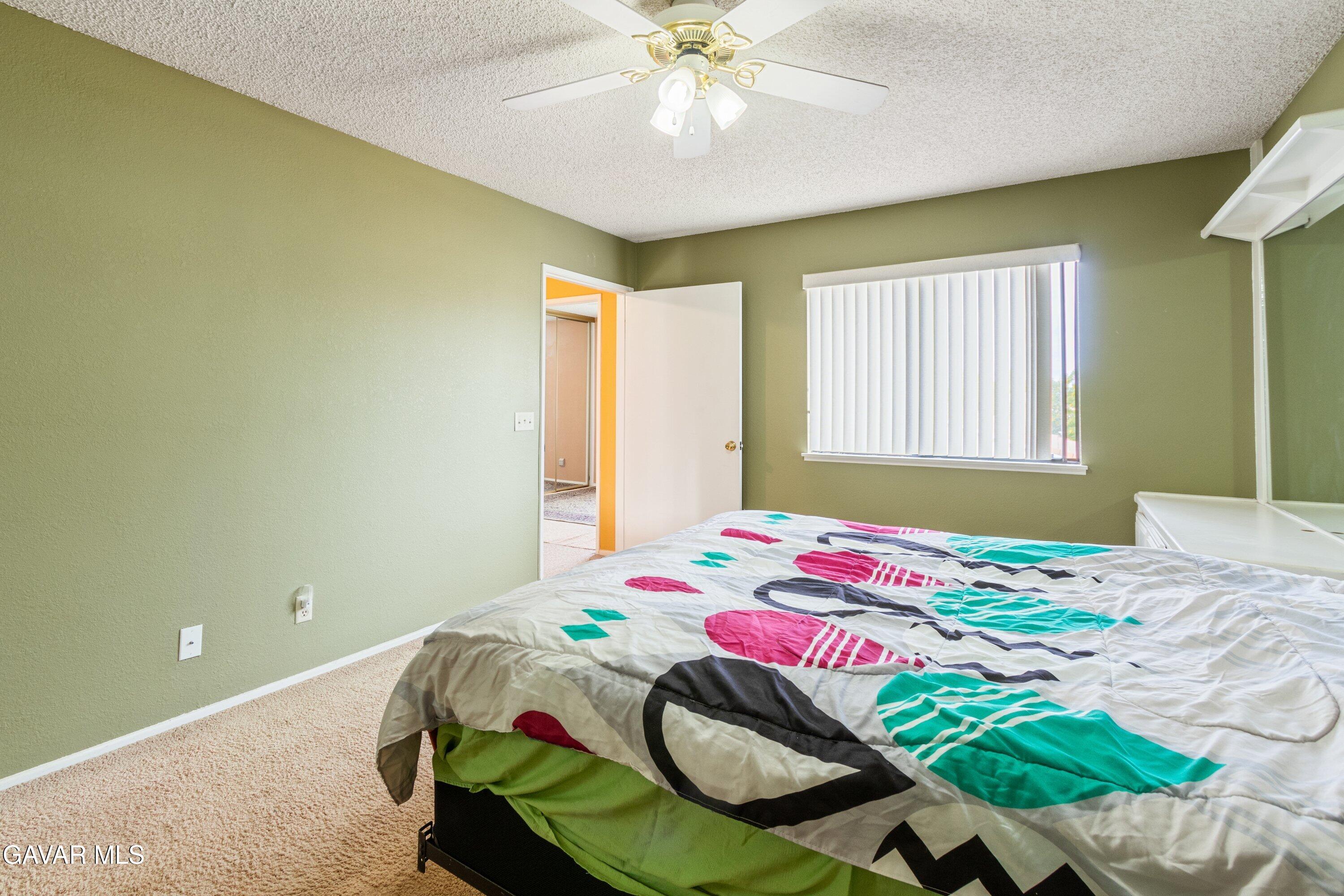 4625 Avenue R6 E Palmdale Ca East Palmdale, CA 93552 - Photo 25 of 25 a bedroom with a bed and a chandelier