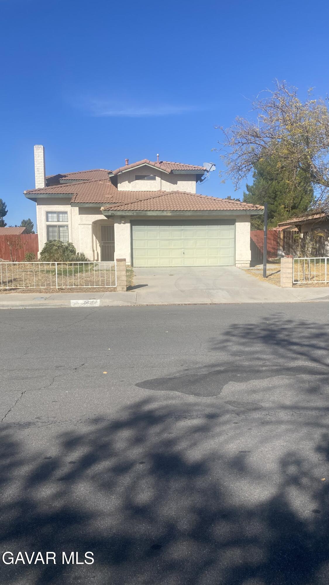 4625 Avenue R6 E Palmdale Ca East Palmdale, CA 93552 - Photo 3 of 25 a front view of a house with a yard and garage