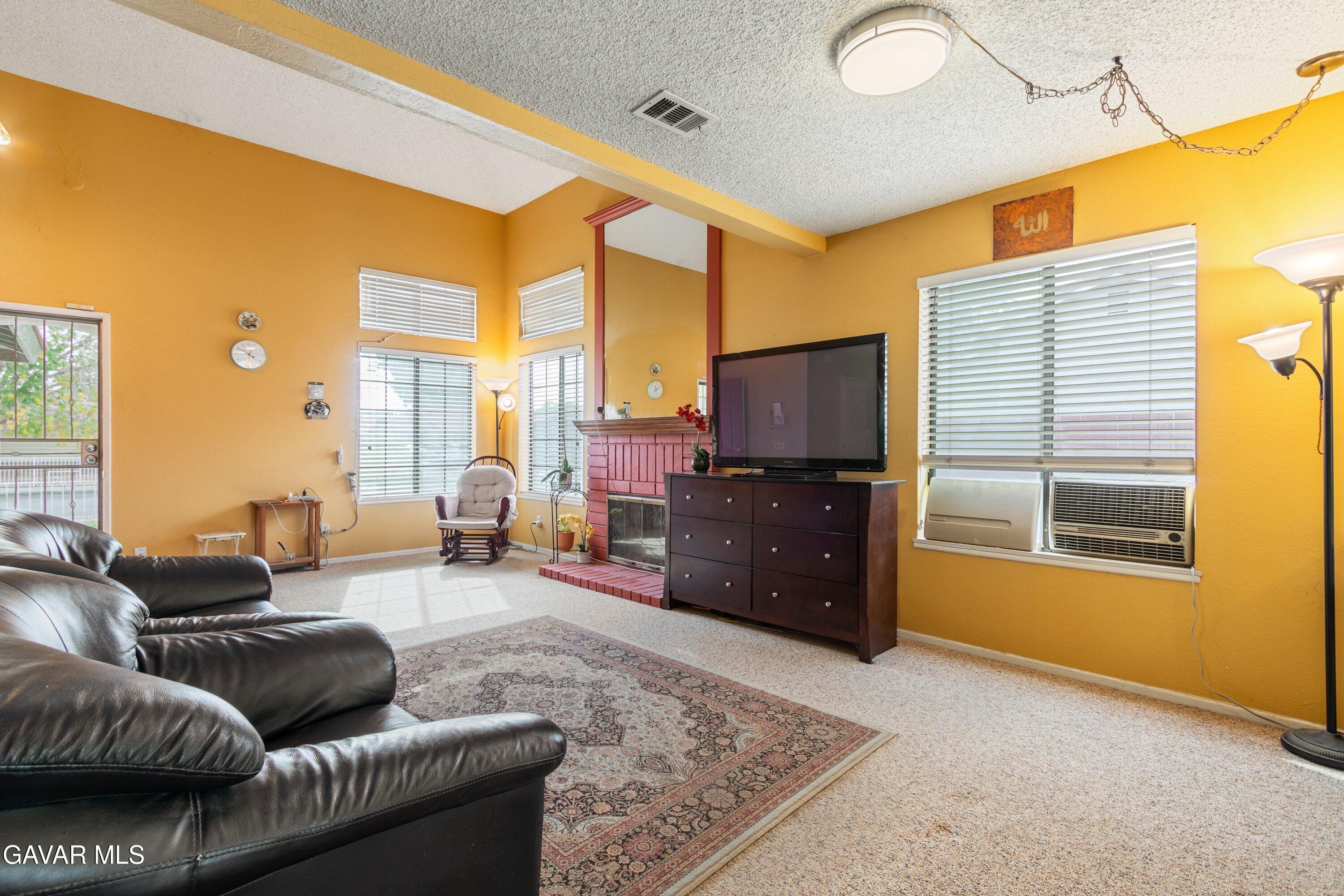 4625 Avenue R6 E Palmdale Ca East Palmdale, CA 93552 - Photo 4 of 25 a living room with furniture and a flat screen tv
