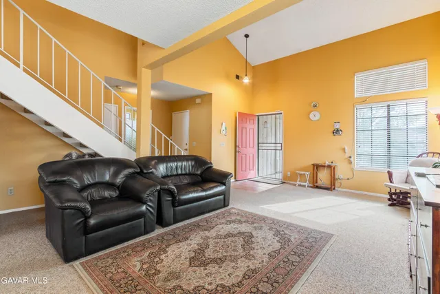 a living room with furniture ceiling fan and a rug