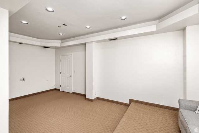 892 Cambridge Drive St. George, UT 84770 - Photo 11 of 65 Open lower-level room featuring patterned carpet flooring and bright white walls