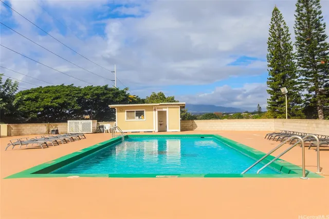 a view of a swimming pool with an outdoor seating
