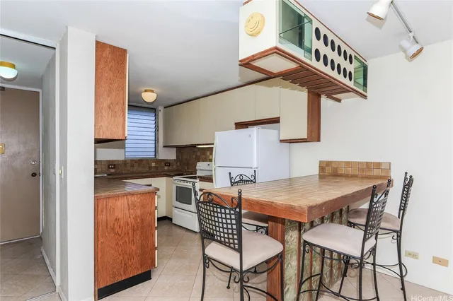 a dining room with a sink a counter space and a window