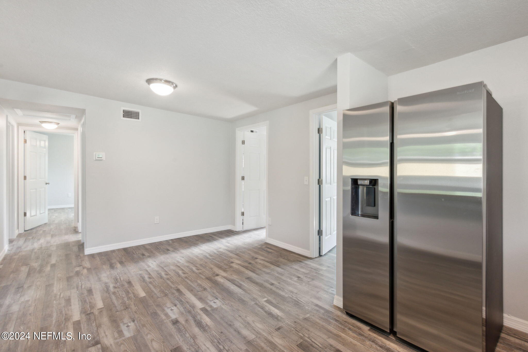 9411 Orme Road Jacksonville, FL 32220 - Photo 15 of 33 a view of a hallway with wooden floor