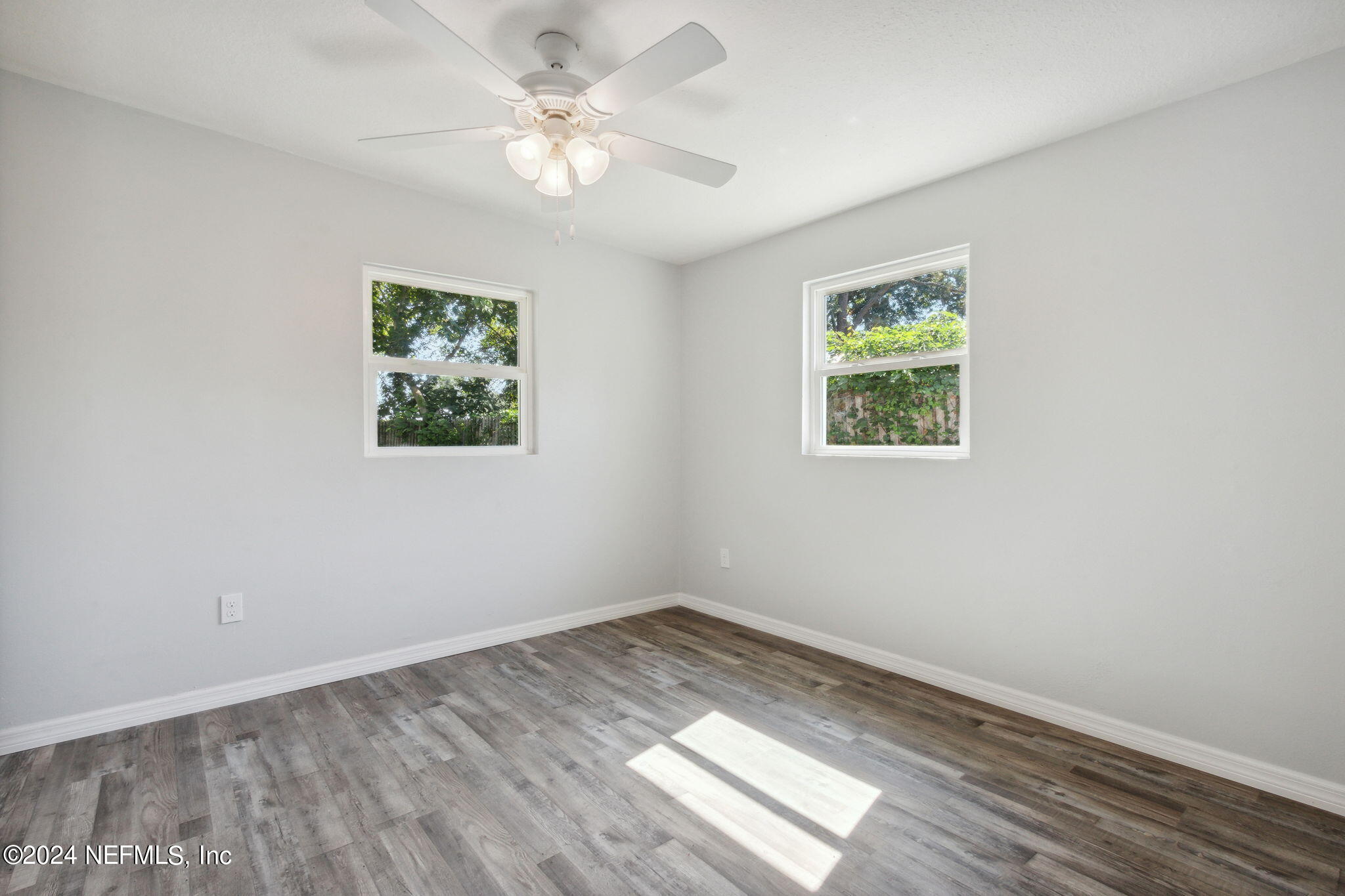 9411 Orme Road Jacksonville, FL 32220 - Photo 17 of 33 a view of empty room with wooden floor