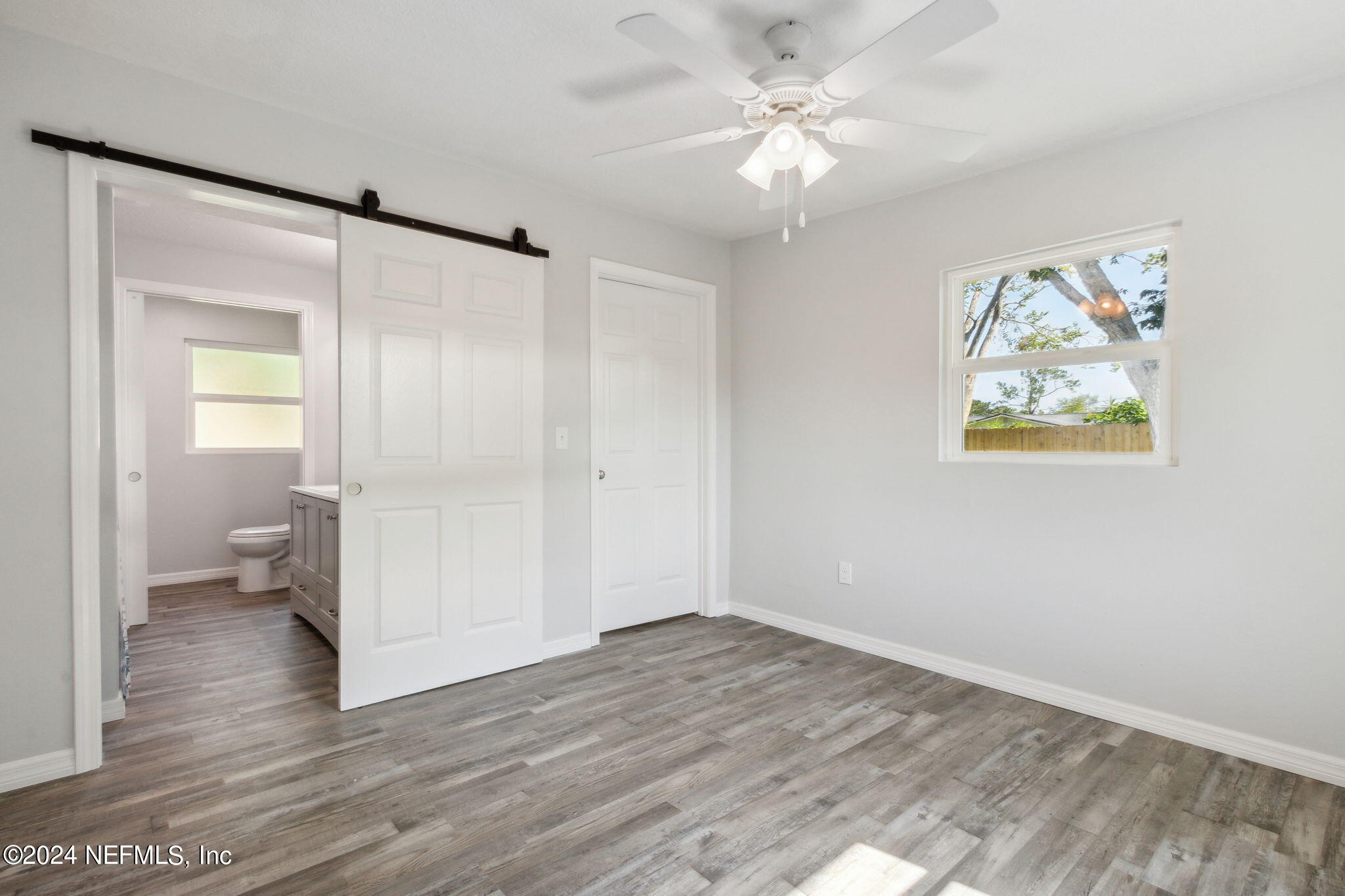 9411 Orme Road Jacksonville, FL 32220 - Photo 19 of 33 wooden floor in an empty room with a mirror