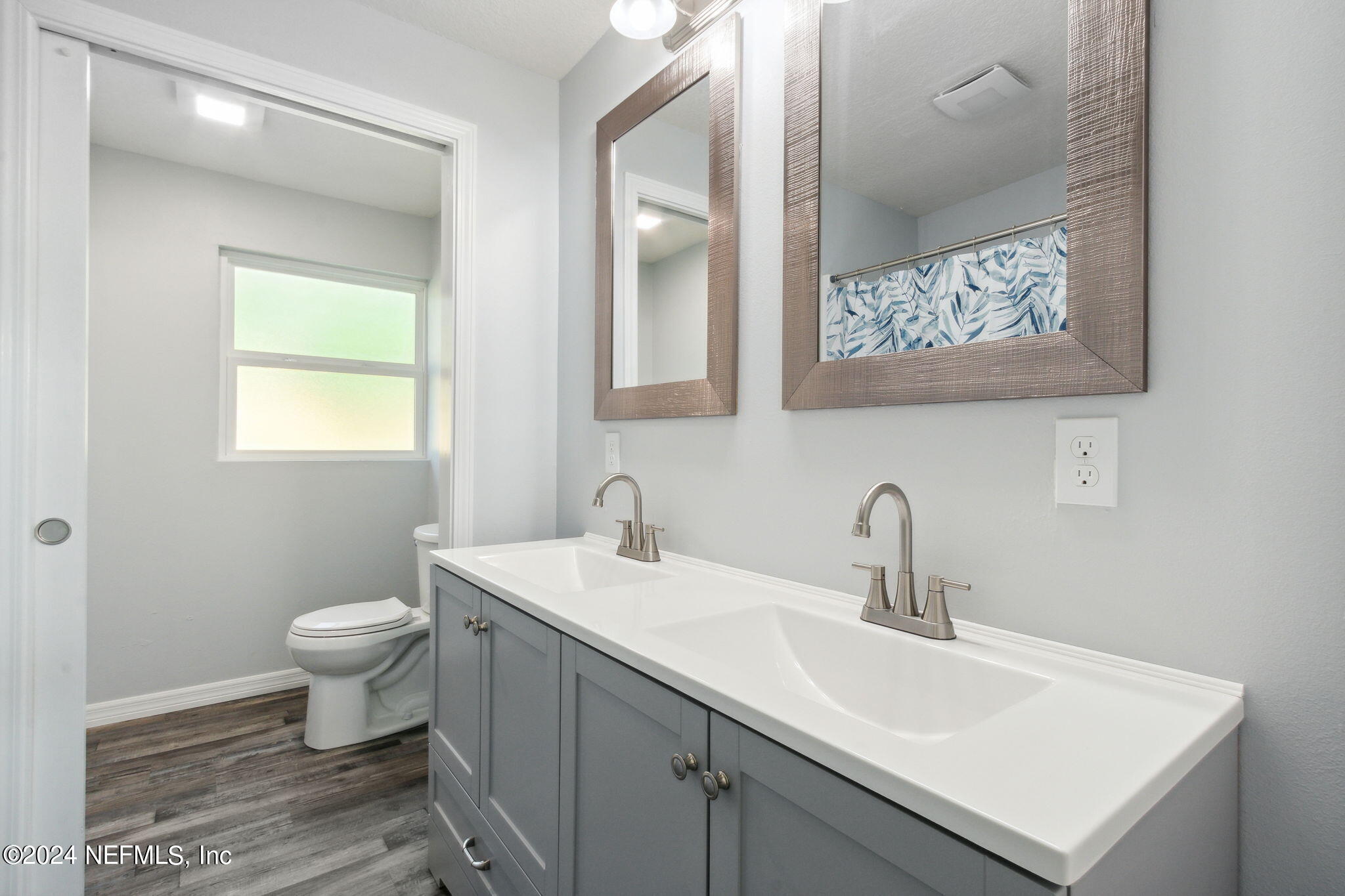 9411 Orme Road Jacksonville, FL 32220 - Photo 20 of 33 a bathroom with a toilet sink and mirror