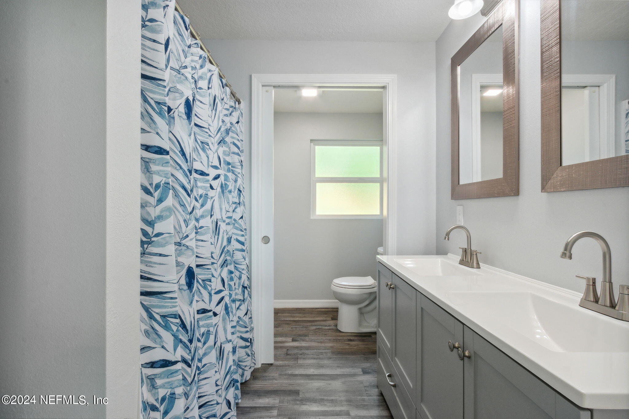9411 Orme Road Jacksonville, FL 32220 - Photo 21 of 33 a bathroom with a toilet sink and mirror
