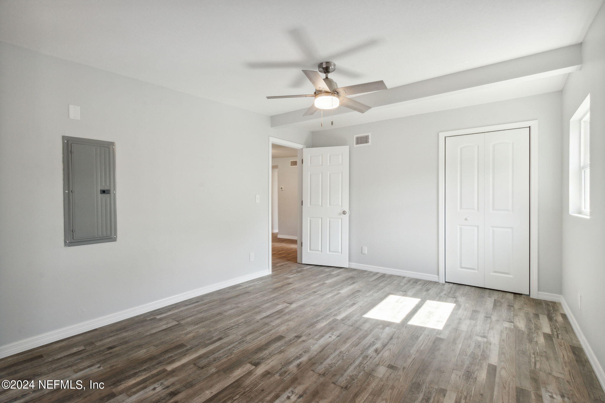 9411 Orme Road Jacksonville, FL 32220 - Photo 24 of 33 a view of empty room with wooden floor and fan