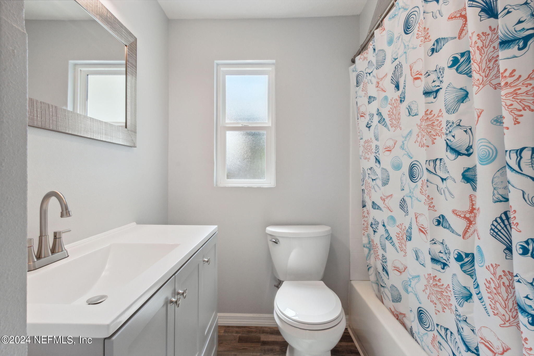 9411 Orme Road Jacksonville, FL 32220 - Photo 25 of 33 a bathroom with a sink toilet and a mirror