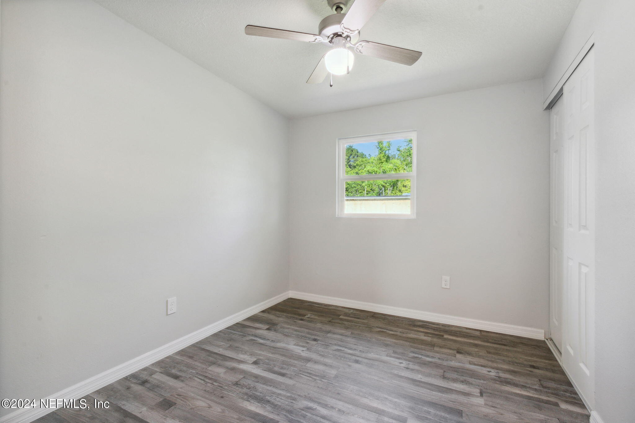 9411 Orme Road Jacksonville, FL 32220 - Photo 26 of 33 an empty room with wooden floor and windows