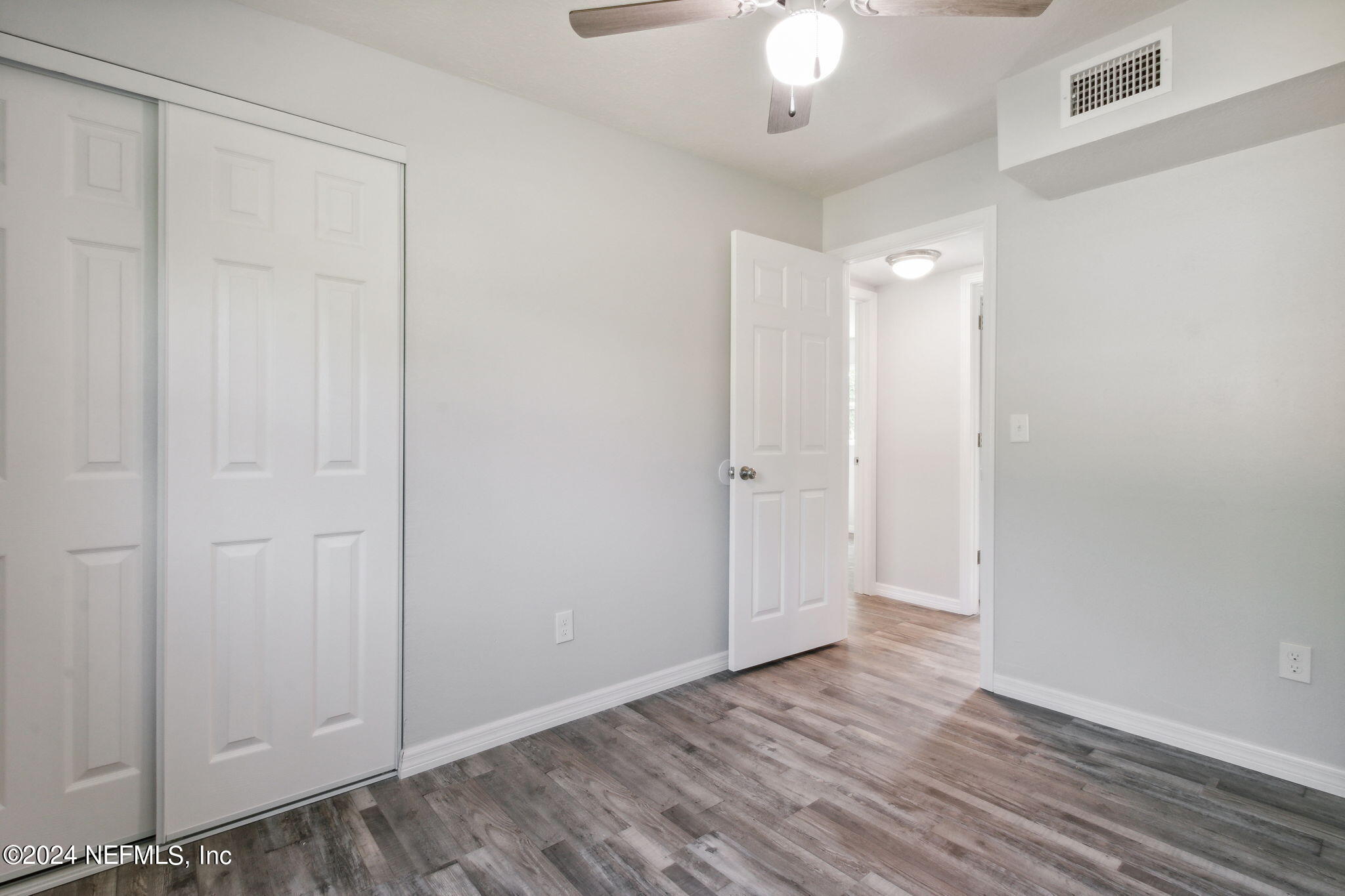 9411 Orme Road Jacksonville, FL 32220 - Photo 27 of 33 a view of an empty room with wooden floor