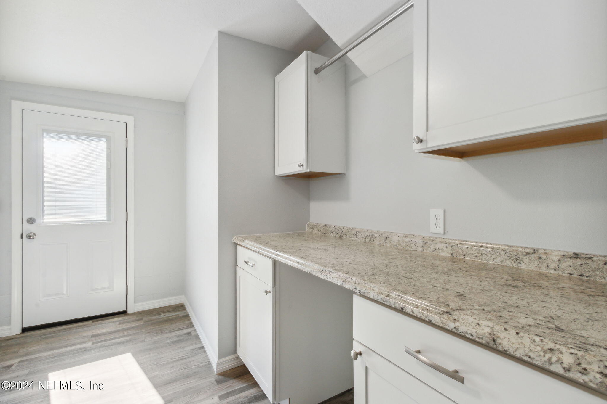 9411 Orme Road Jacksonville, FL 32220 - Photo 28 of 33 a kitchen with granite countertop a sink and a white cabinets