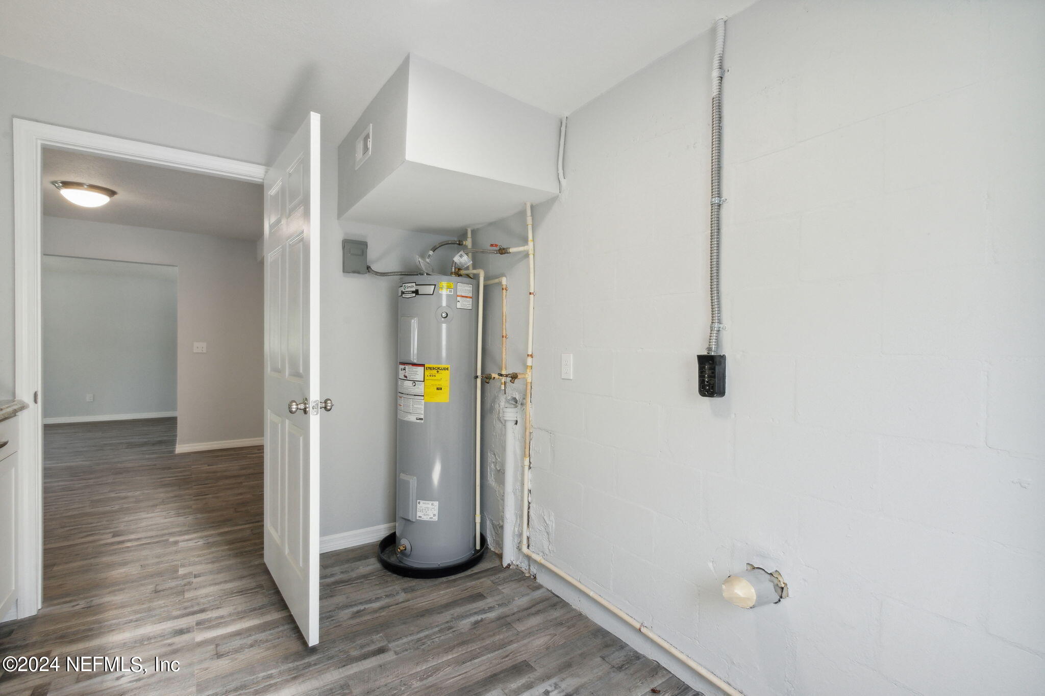 9411 Orme Road Jacksonville, FL 32220 - Photo 29 of 33 a view of a hallway with wooden floor