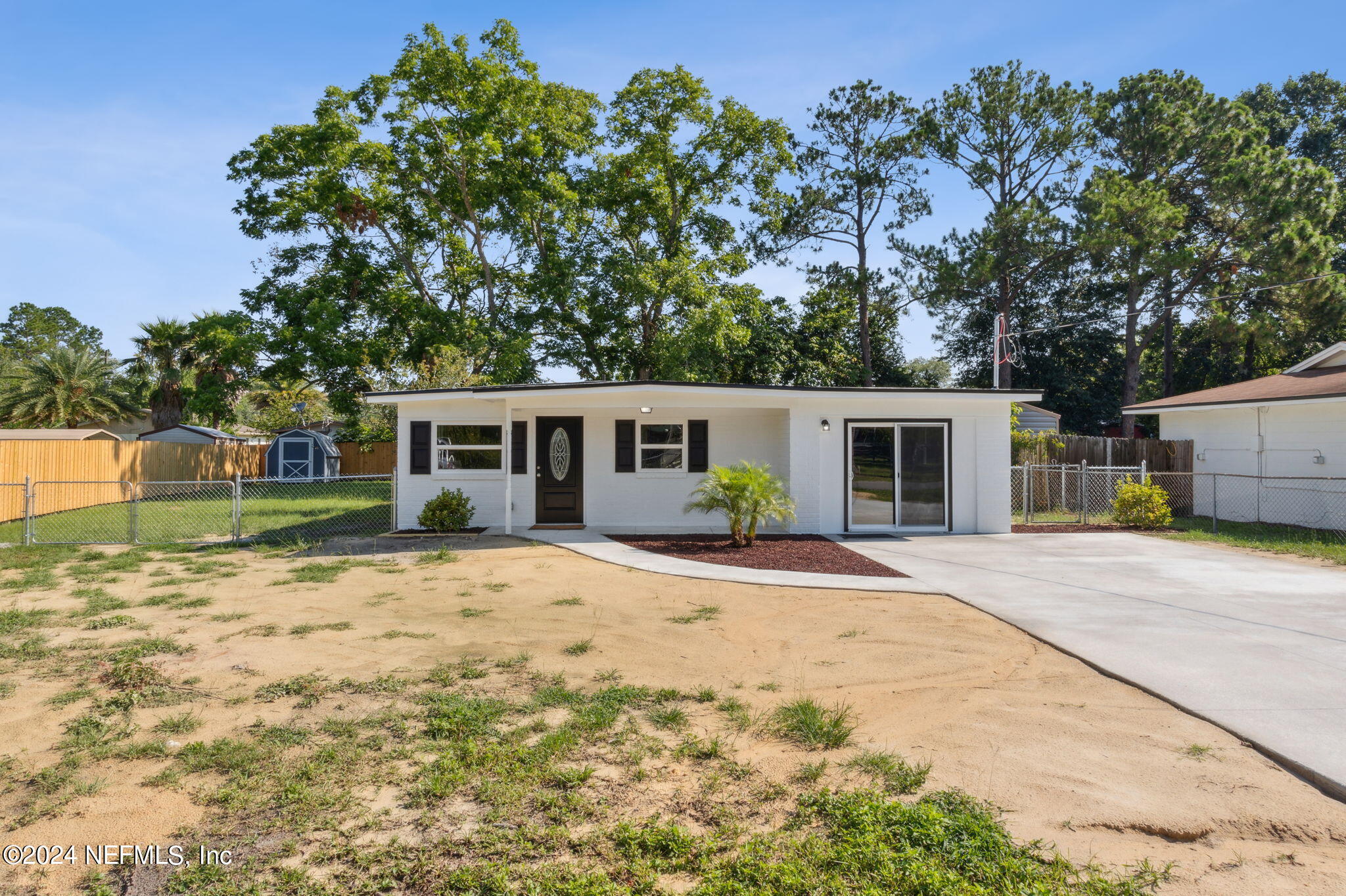 9411 Orme Road Jacksonville, FL 32220 - Photo 4 of 33 a front view of a house with a garden
