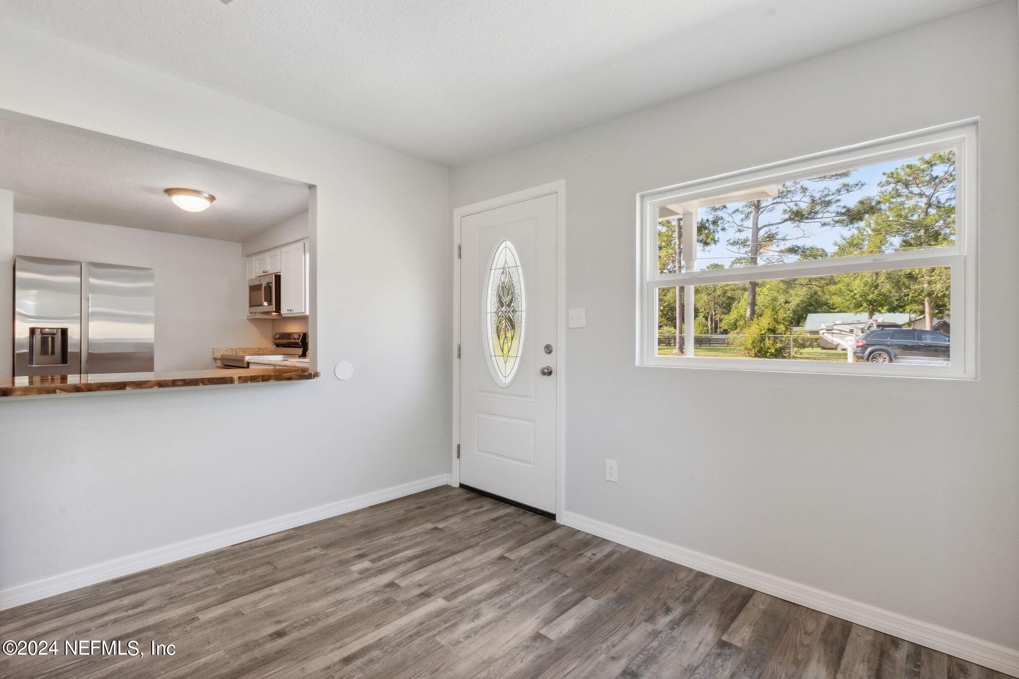 9411 Orme Road Jacksonville, FL 32220 - Photo 5 of 33 a view of kitchen with wooden floor electronic appliances and window