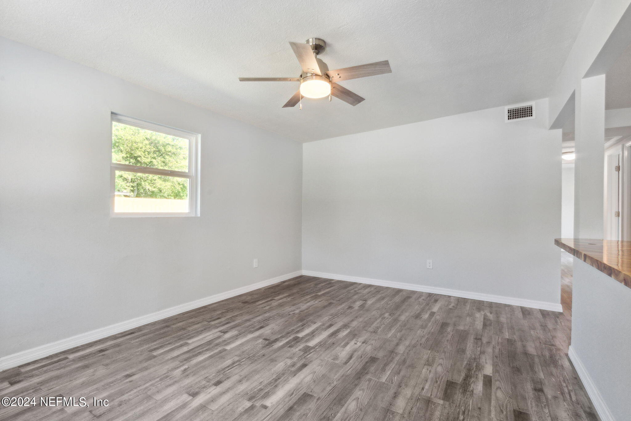 9411 Orme Road Jacksonville, FL 32220 - Photo 7 of 33 wooden floor in an empty room with a window