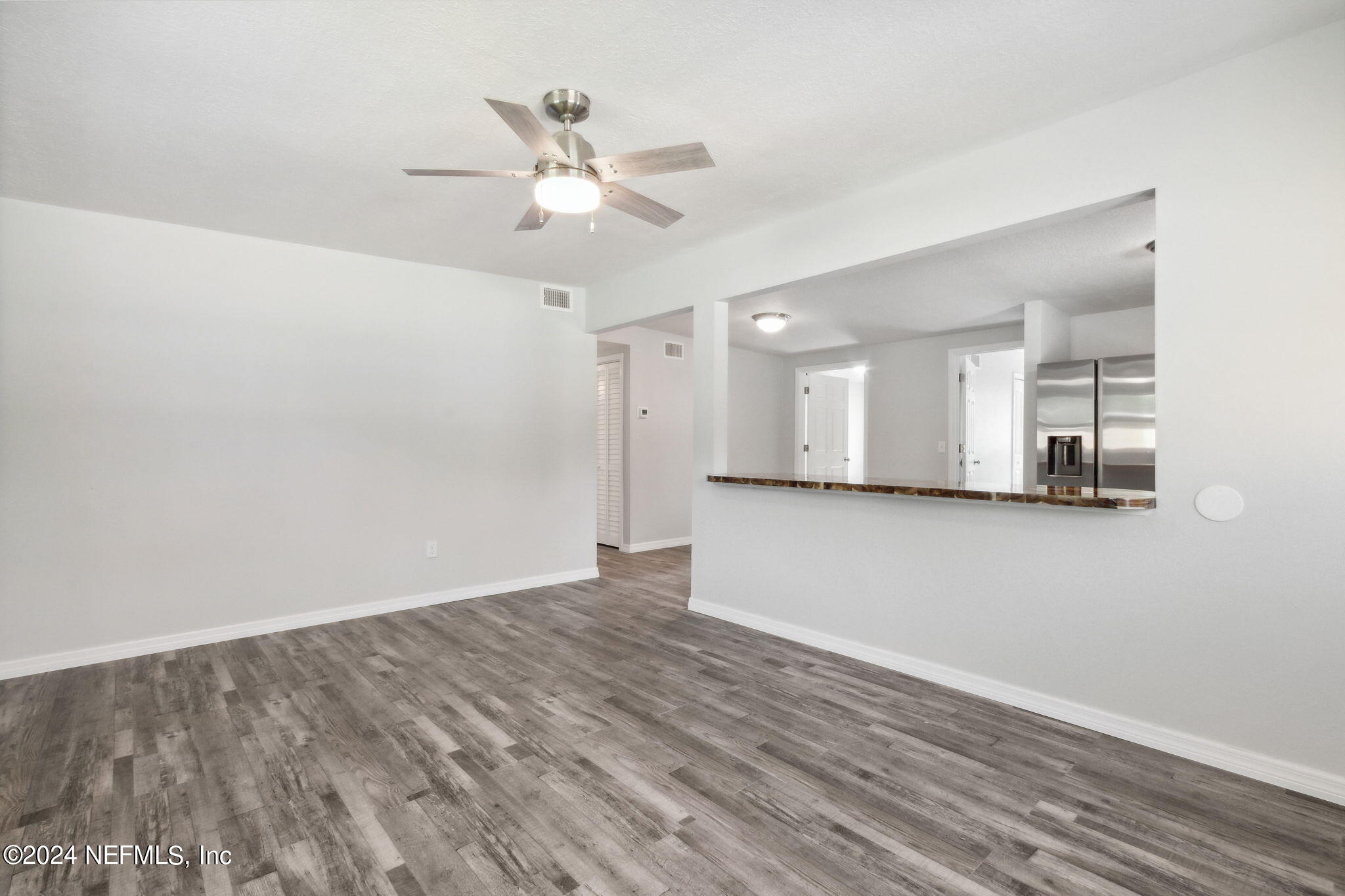 9411 Orme Road Jacksonville, FL 32220 - Photo 8 of 33 wooden floor in an empty room with a window