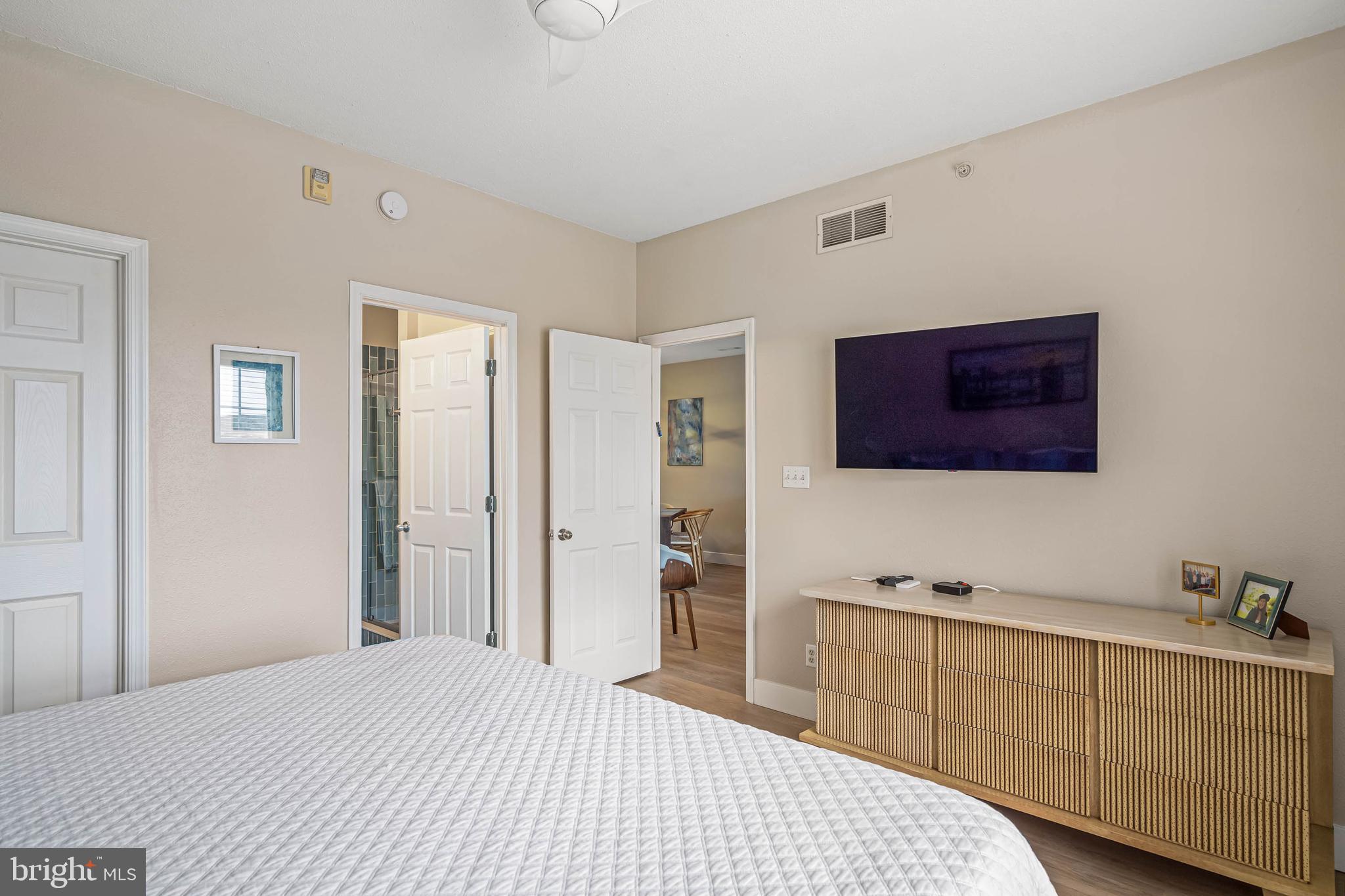 33156 North Village Loop, Unit 4302 Lewes, DE 19958 - Photo 14 of 34 a bedroom with a bed and a flat screen tv