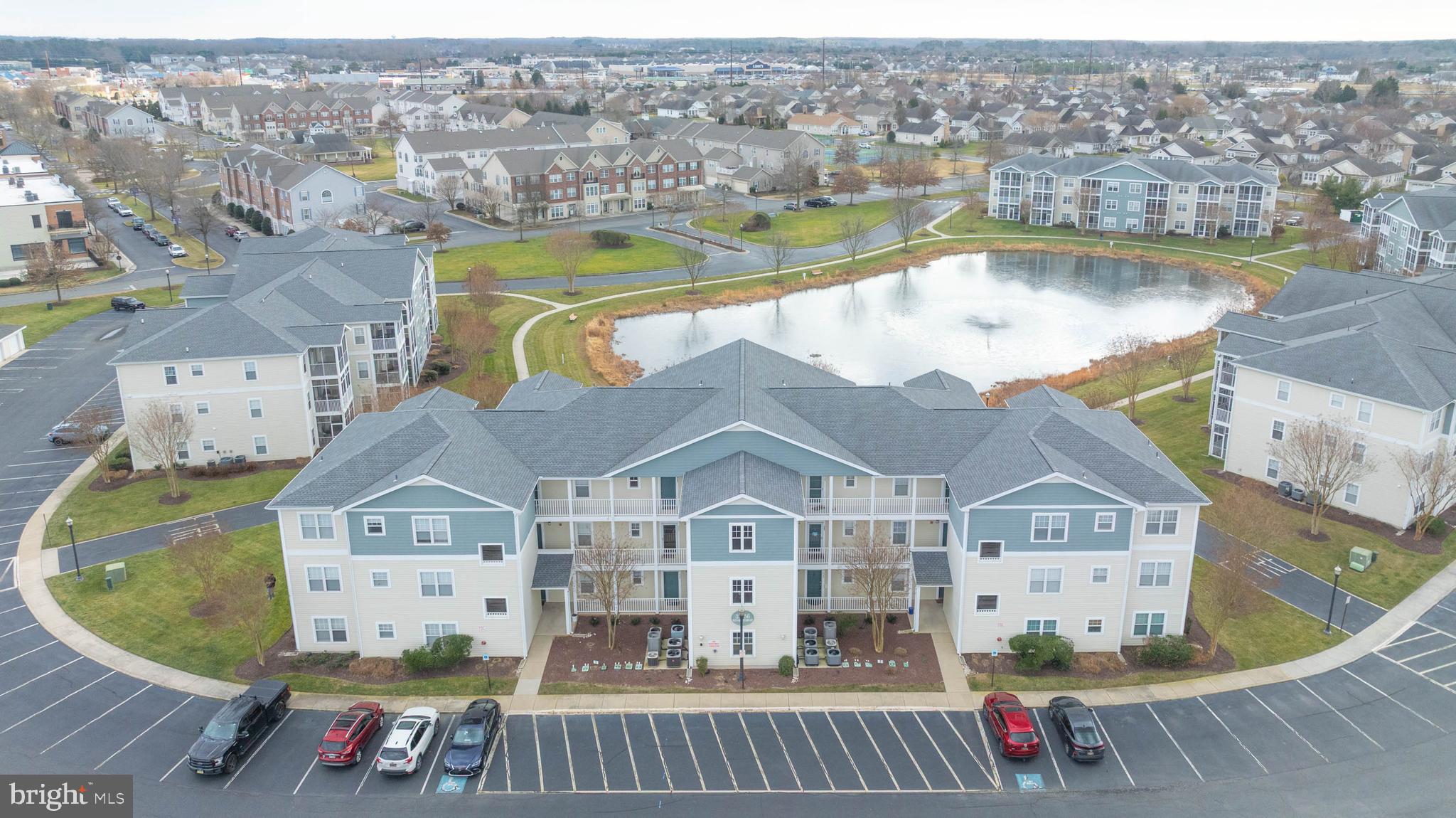 33156 North Village Loop, Unit 4302 Lewes, DE 19958 - Photo 30 of 34 an aerial view of a house with swimming pool