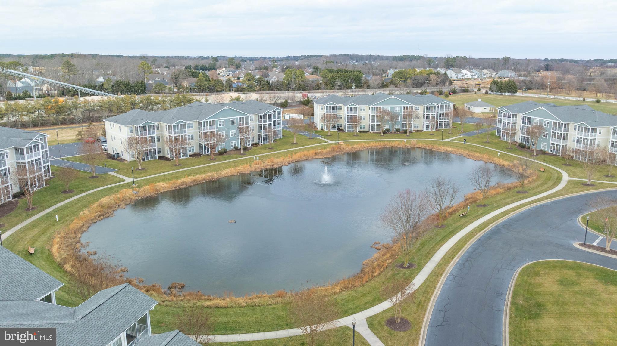 33156 North Village Loop, Unit 4302 Lewes, DE 19958 - Photo 31 of 34 a view of a swimming pool with a lake view