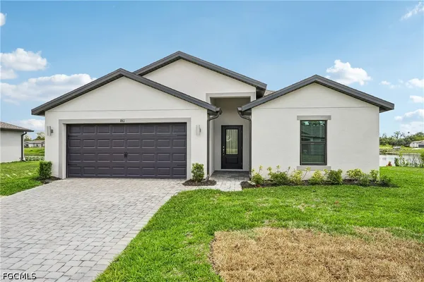 a front view of house with yard and green space