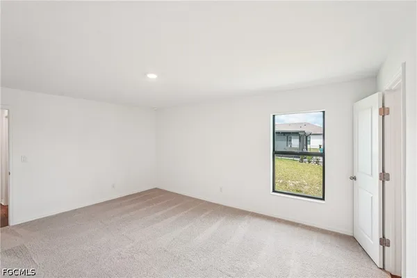 an empty room with windows and entrance