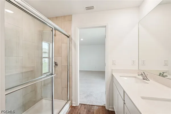 a bathroom with a double vanity sink and mirror