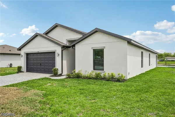 a front view of a house with a yard