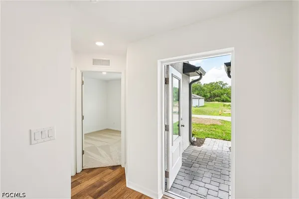 a view of a hallway with a livingroom and a livingroom with furniture