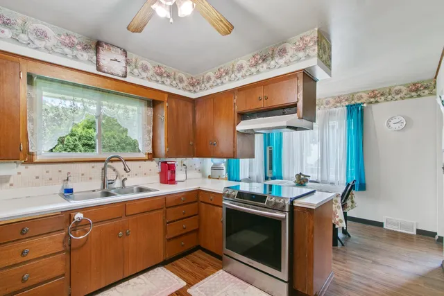 a kitchen with granite countertop a refrigerator and a sink