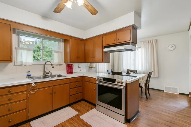 a view of a dining room with furniture and chandelier