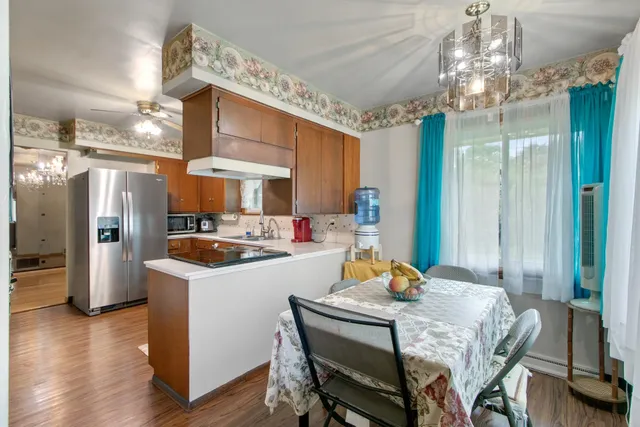 a bedroom with a bed and a large mirror on the dresser