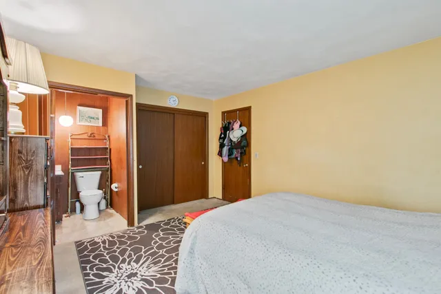 a bedroom with a large bed and a window