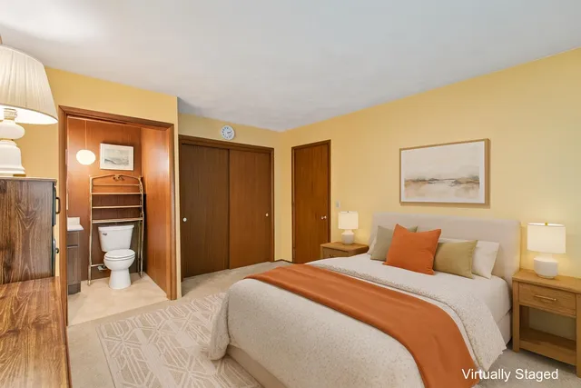 a bedroom with a bed and a flat tv screen