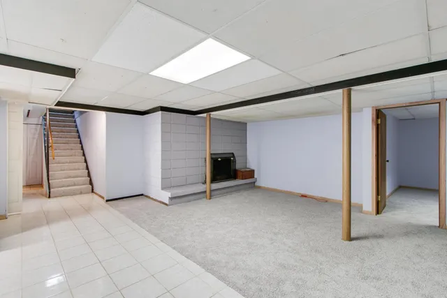 a bedroom with a large bed and a potted plant