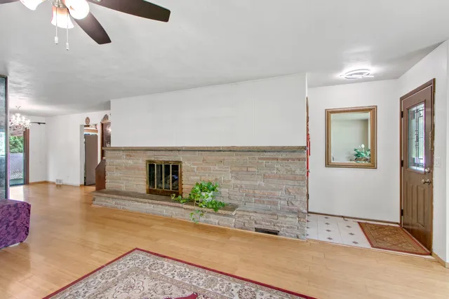 a view of a hallway with wooden floor and windows