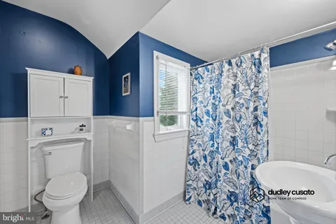a white toilet sitting next to a bathroom sink