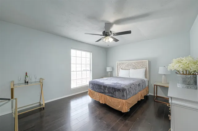 a bedroom with a bed chandelier and a window