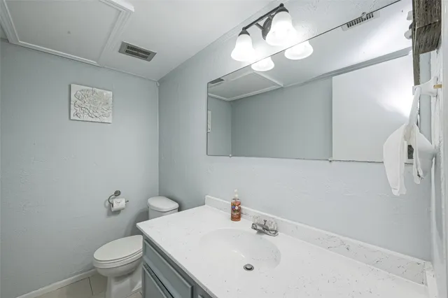 a bathroom with a sink toilet and a mirror
