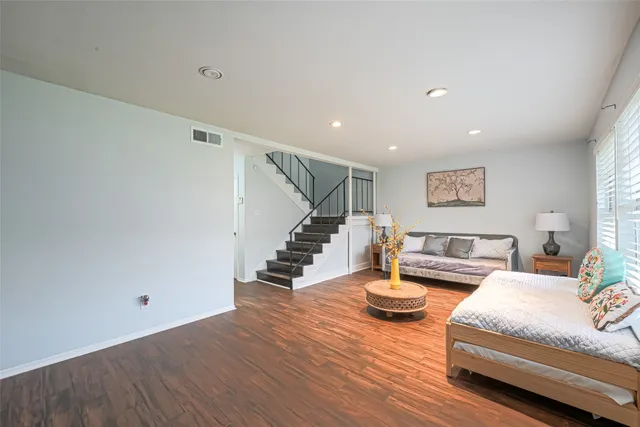 a living room with furniture and wooden floor
