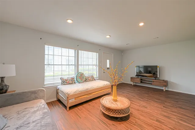 a spacious bedroom with a bed and a couch