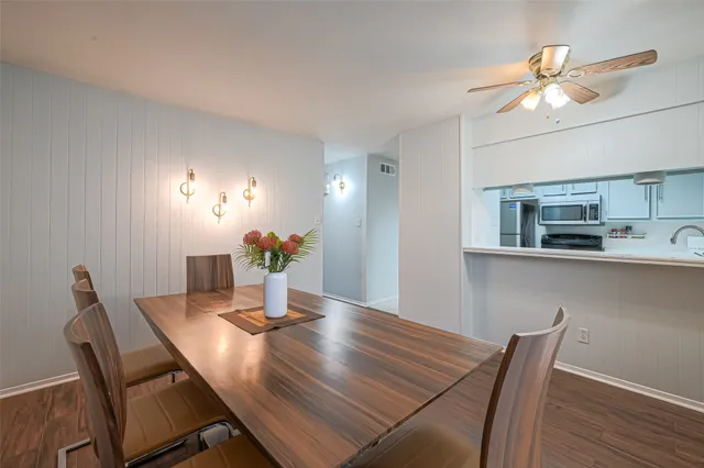 a view of a dining room with furniture and wooden floor