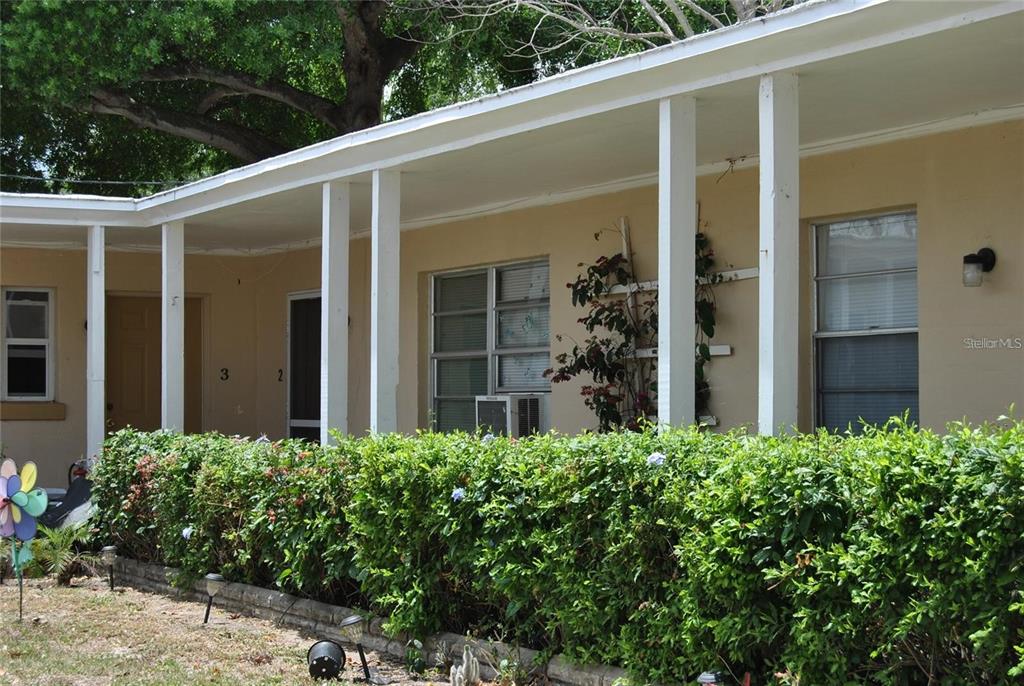 front view of a house with potted plants
