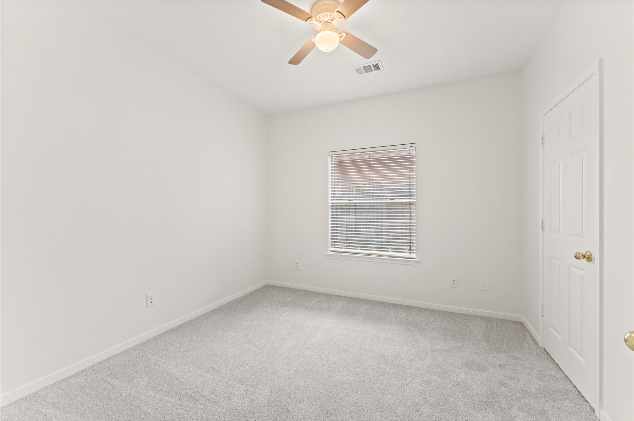 23834 Spring Dane Drive Spring, TX 77373 - Photo 19 of 19 an empty room with a window and a fan