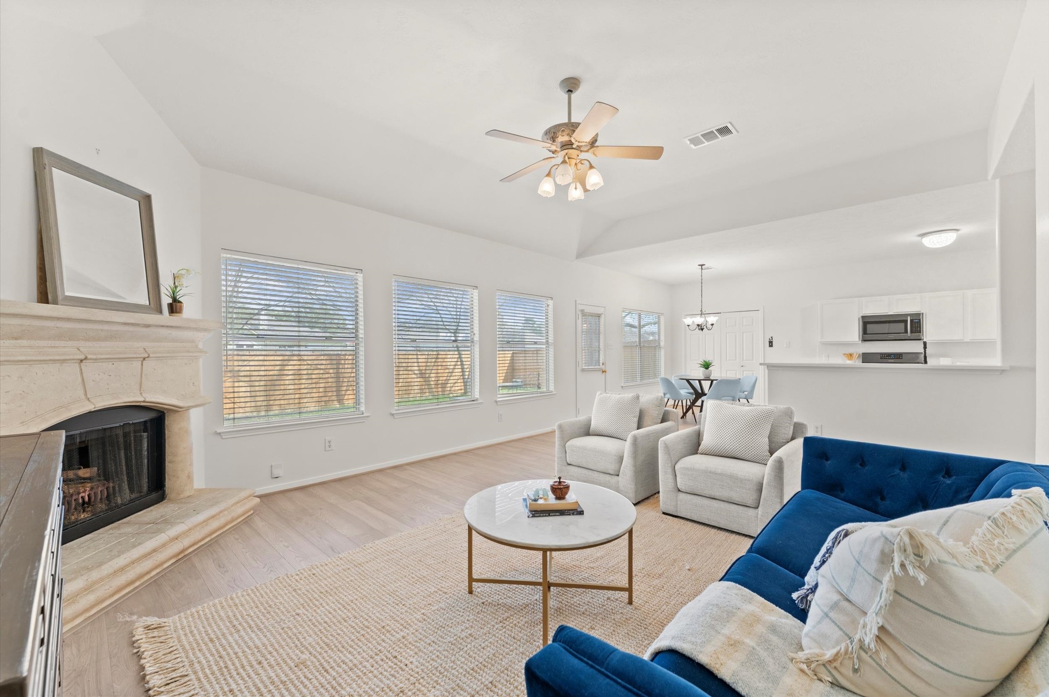 23834 Spring Dane Drive Spring, TX 77373 - Photo 3 of 19 A stylish wood-burning fireplace is an attractive focal point as it provides beauty and warmth on a cool evening. Notice the open layout that easily connects the kitchen and dining area.