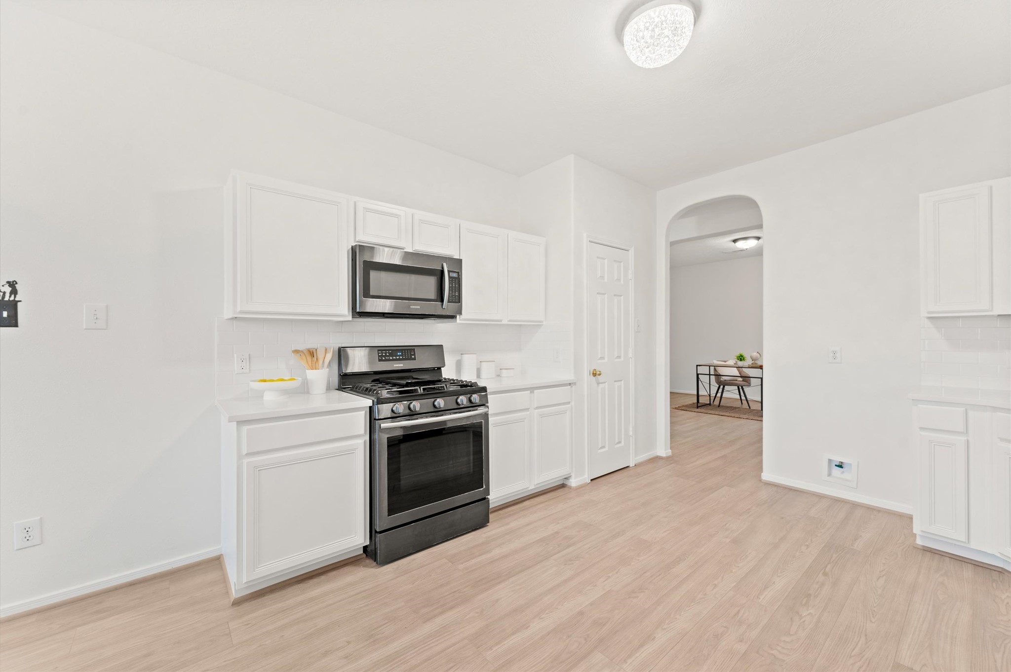23834 Spring Dane Drive Spring, TX 77373 - Photo 6 of 19 Another view of the arched doorway shows the versatile space behind the kitchen set up as an office. It could easily serve as a dining room or formal sitting area as well. To the left of the archway, you'll find the pantry.