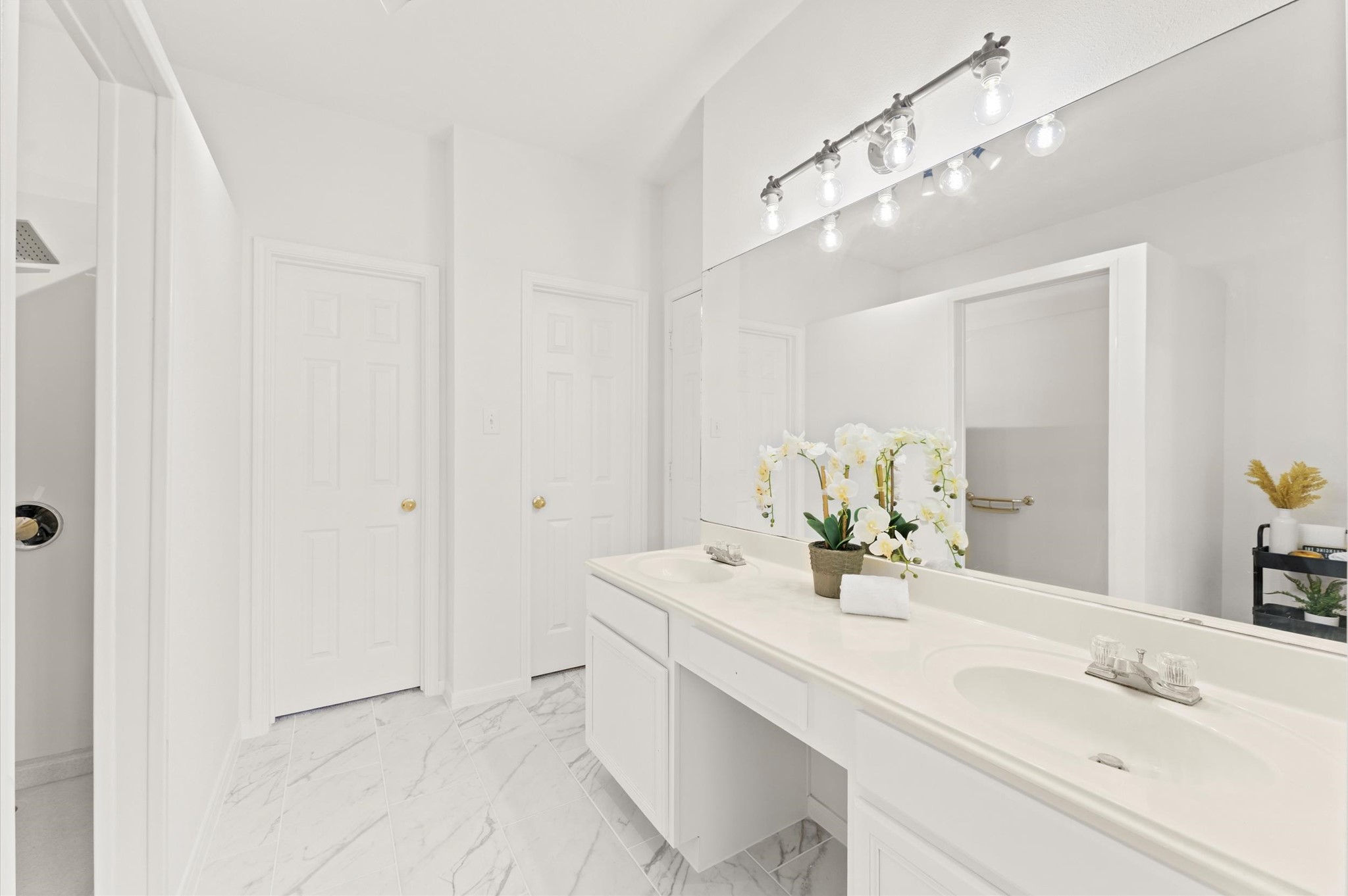 23834 Spring Dane Drive Spring, TX 77373 - Photo 10 of 19 The primary bath is open and bright, featuring a double sink vanity under an oversized mirror and elegant lighting.